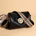 Bolsa feminina de couro com design elegante e moderno, detalhe metálico central e alça larga com listras. Ideal para uso casual e social. Versátil e sofisticada.